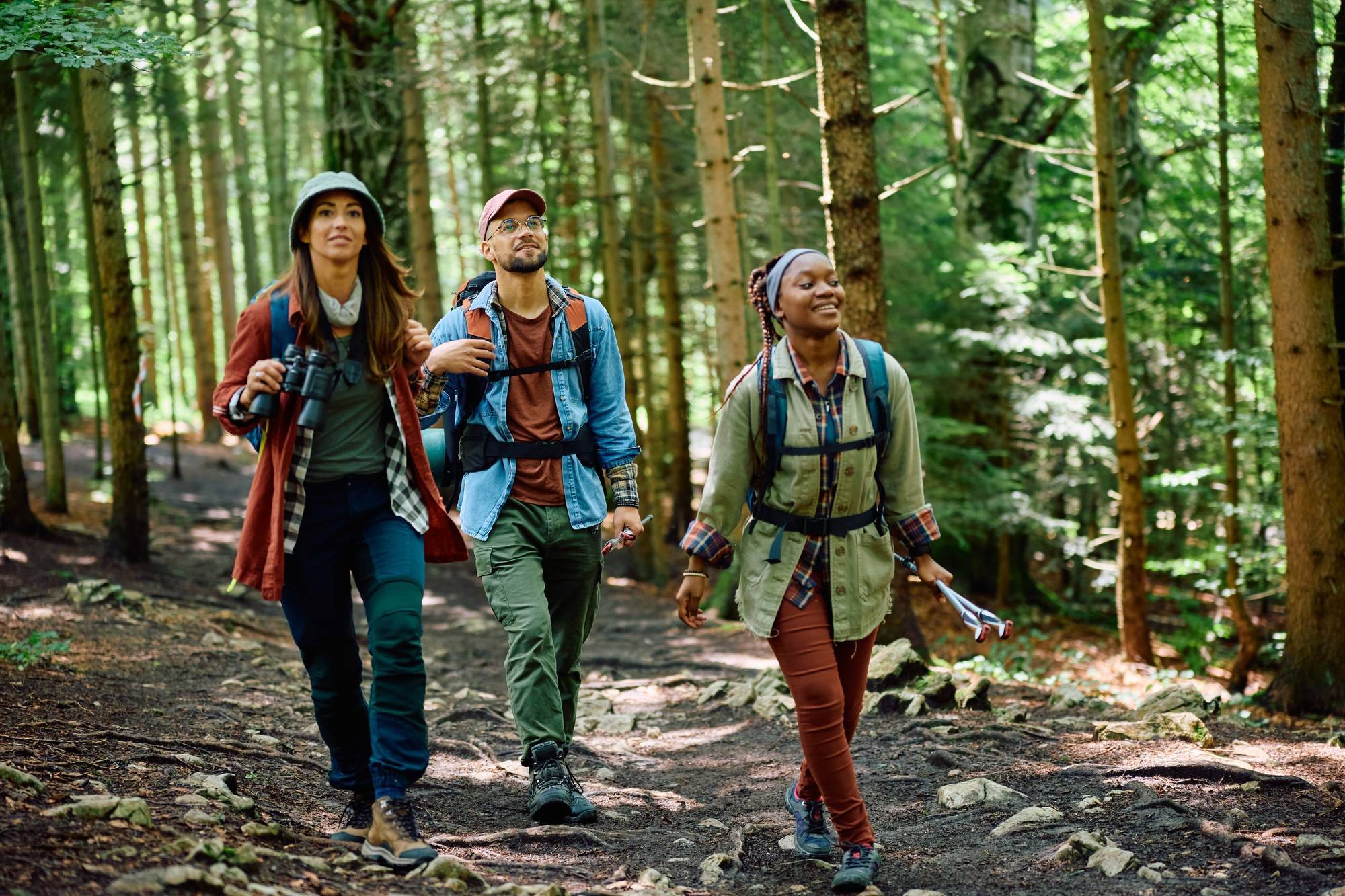 Group of young hikers walking through the woods.